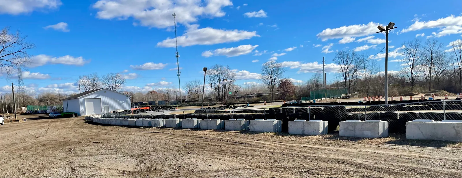 A long run of concrete barrier blocks along the track at Jackson Speedway, backed by a wall of tires