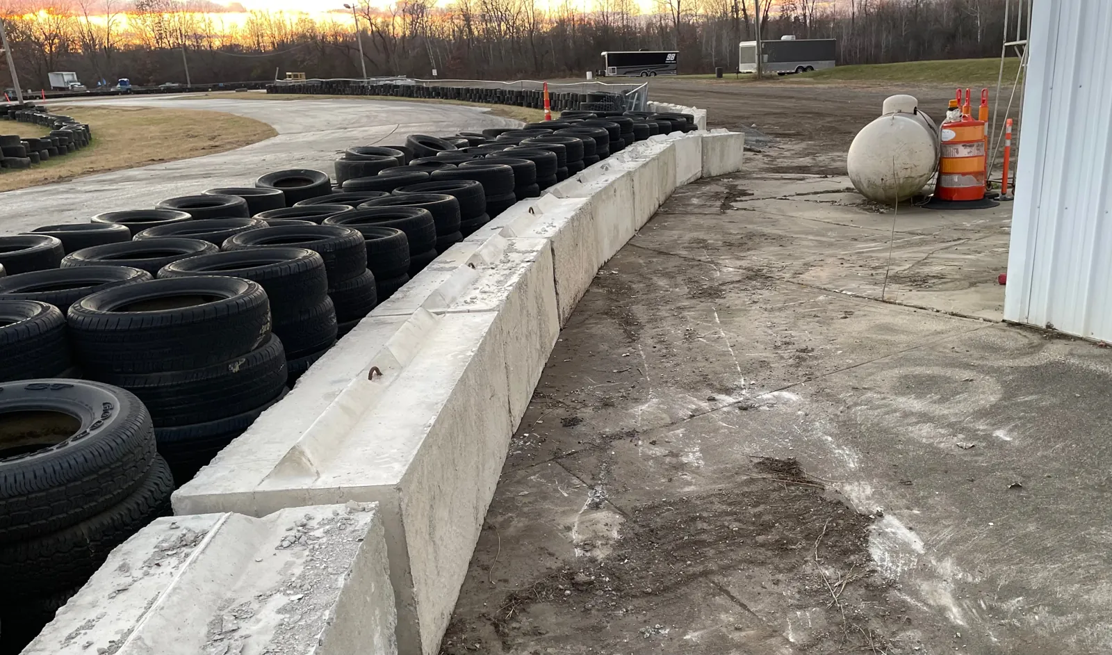 Close-up of the concrete block wall and tire stack at the edge of the Jackson Speedway course